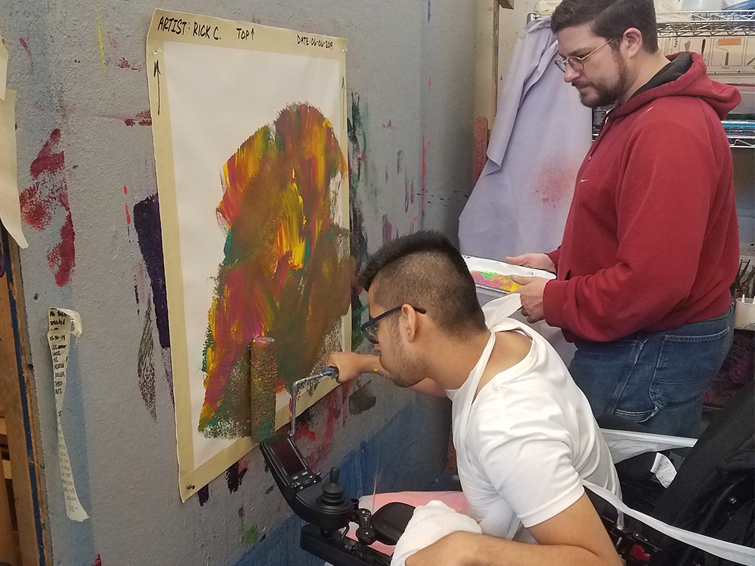 Artist Rick Cruz at work in the art studio at the Robert Schonhorn Arts Center.