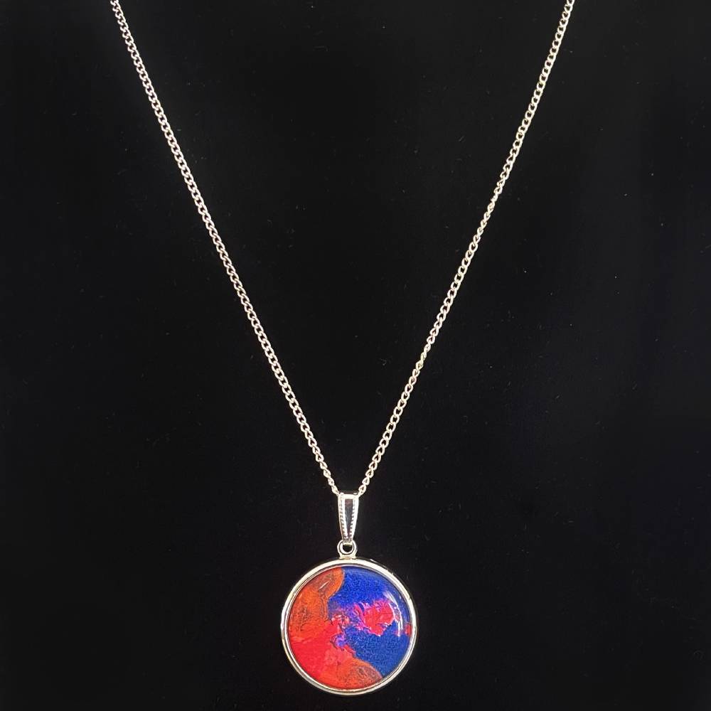 Silver pendant necklace featuring artwork by Amy Myers.