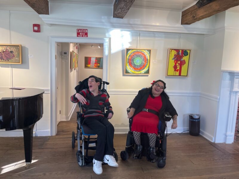 Artists Anthony Zaccaria and Isabell Villacis with exhibited paintings in the Farmstead Arts gallery.