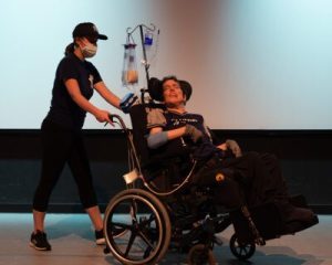 Choreographer Andy Lash with Dance Facilitator Alyssa Thostesen on stage at Robert Schonhorn Arts Center, during Dance Day filming.