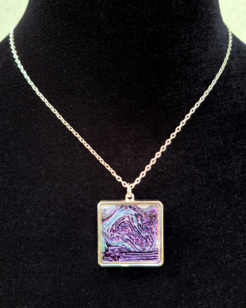 Pendant necklace based on a painting titled "Animal Buffalo Tennis" by artist Josh Handler.