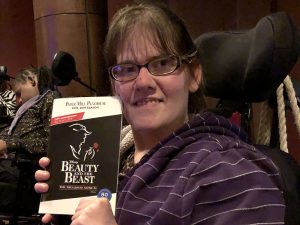 Amanda holds up her program for "Beauty and the Beast"