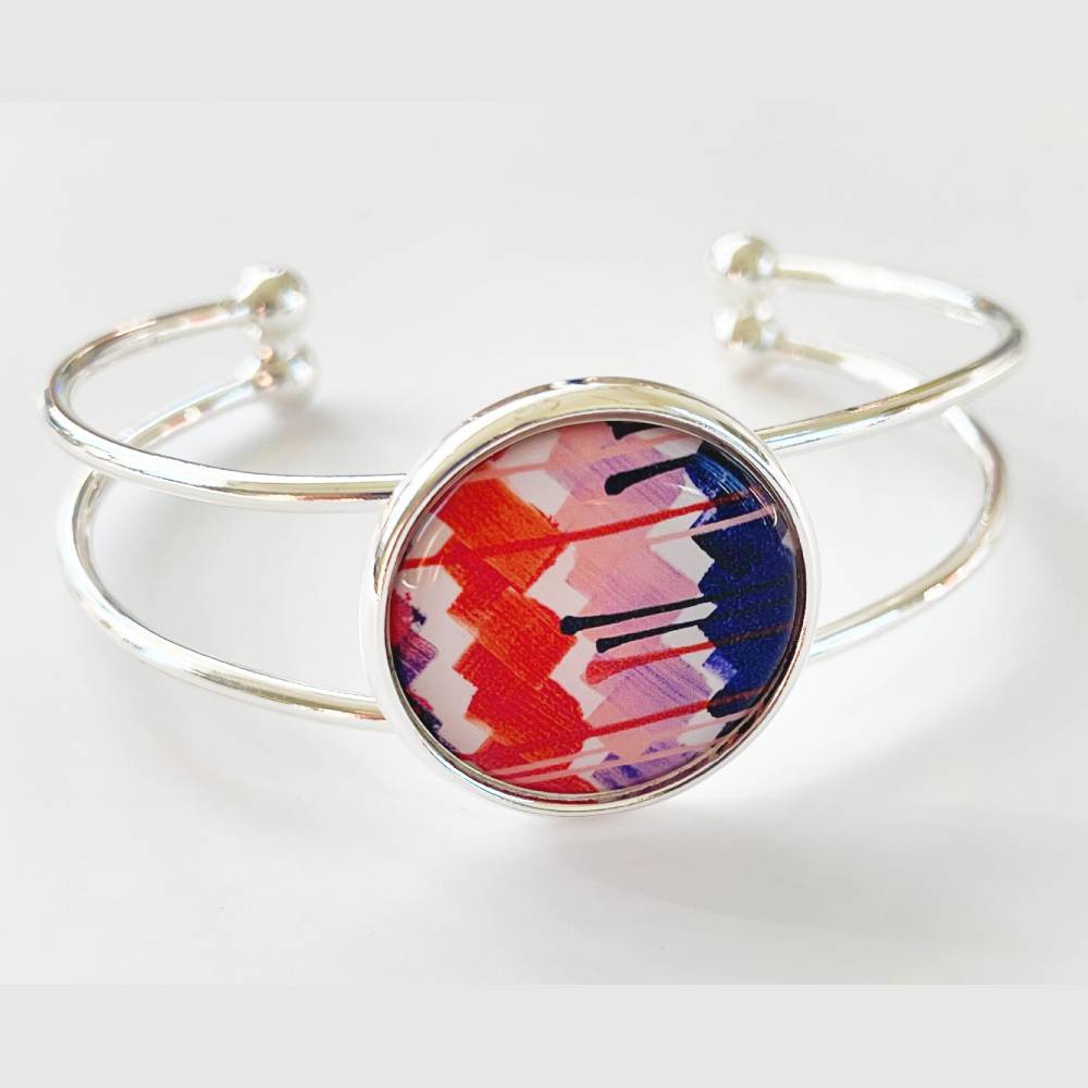 Silver bangle bracelet featuring artwork by Jasmine Oliver.
