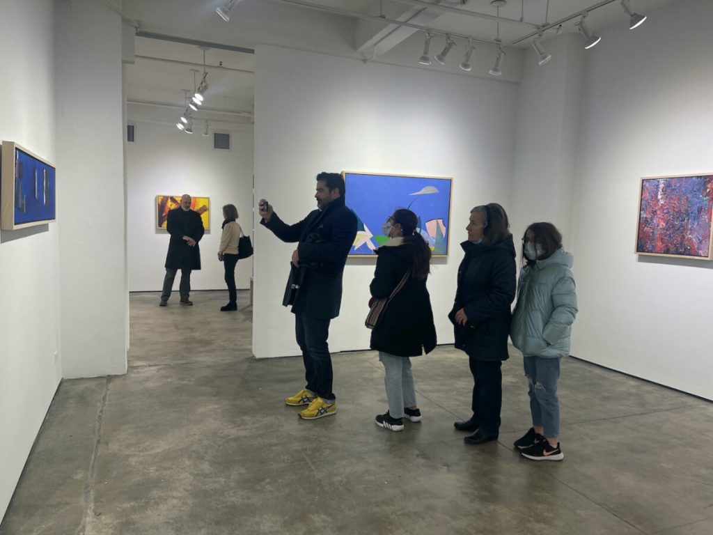 Guests viewing exhibited paintings at Kathryn Markel opening reception.