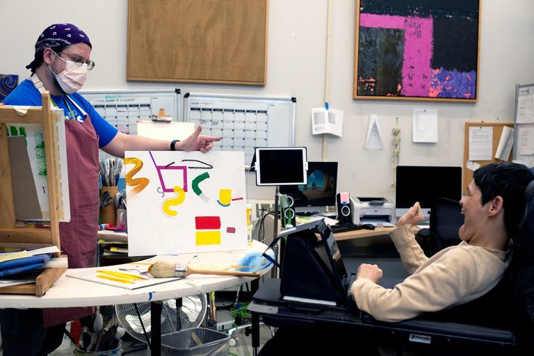 Artist Ellen Kane at work in the Robert Schonhorn Arts Center studio with Painting Facilitator Stephen Haluska.