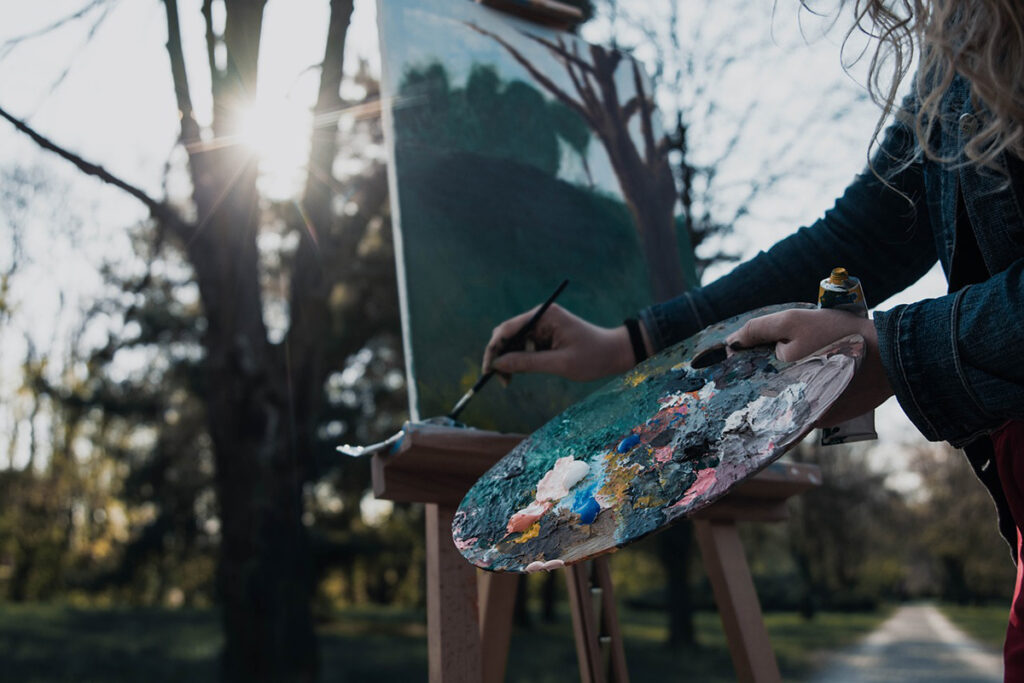 person painting outside, in plein air