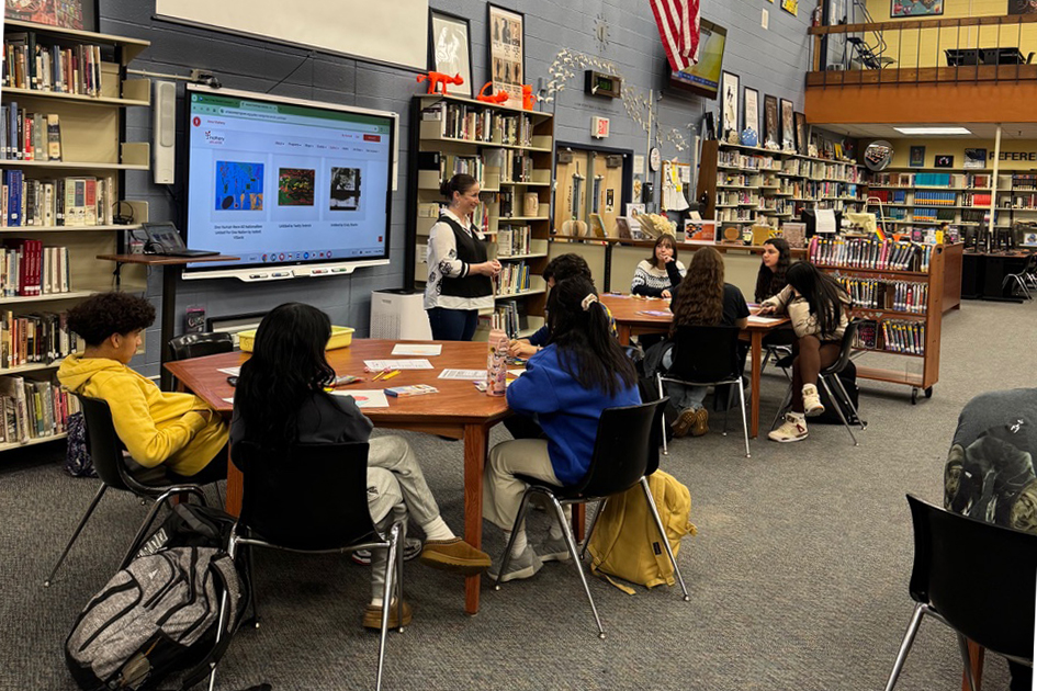 High school students in a library, watching a presentation by Matheny Arts Access