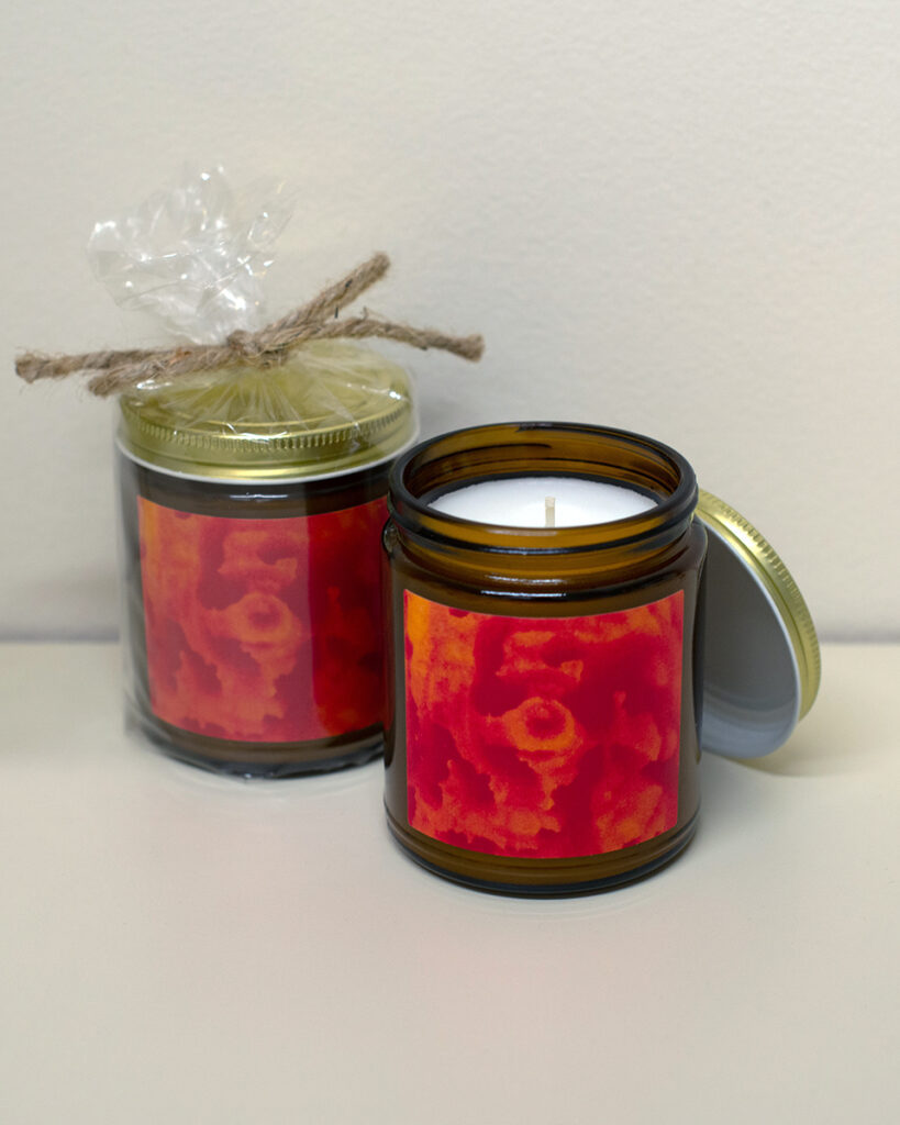 Amber jar candle featuring artwork by Paul Santo.