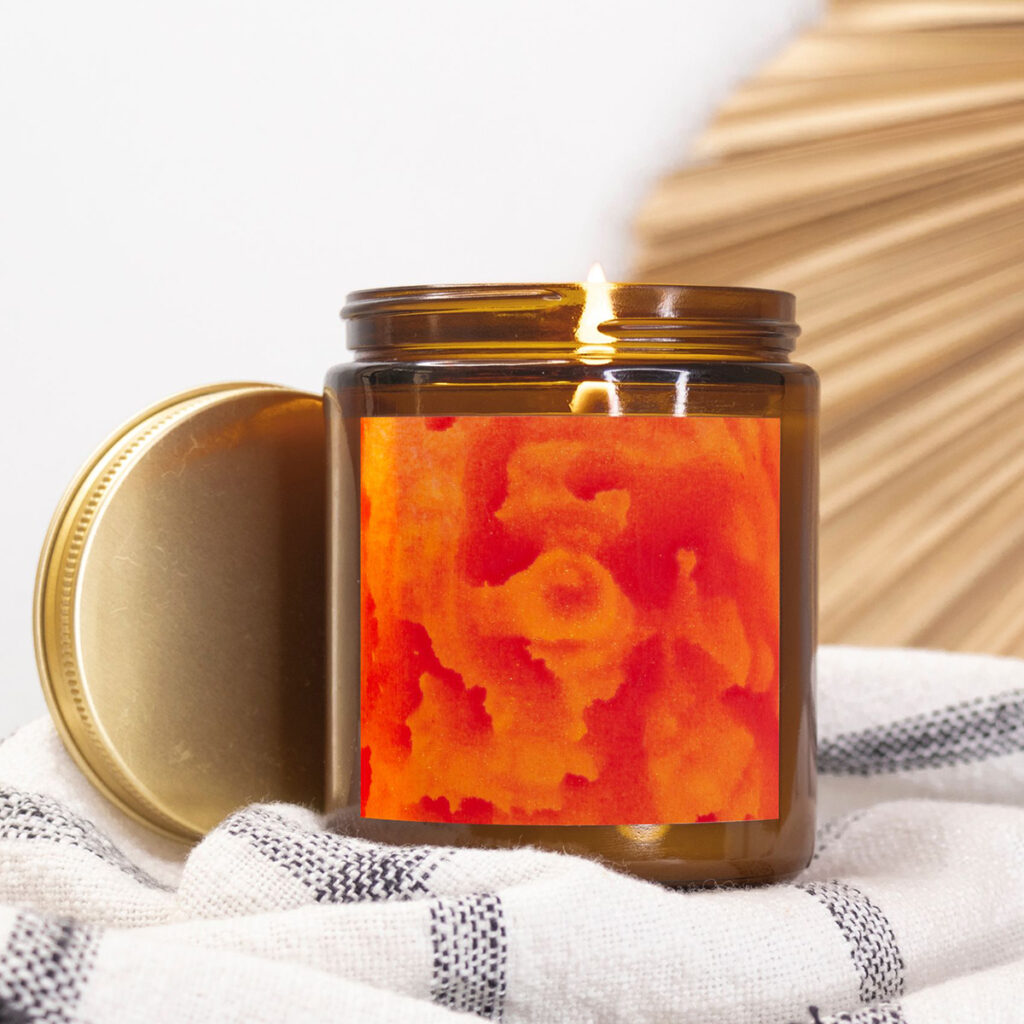 Amber jar candle featuring artwork by Paul Santo.