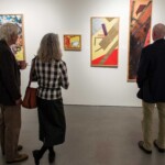 Guests viewing Arts Access exhibited works at Sotheby's New York artists' reception.