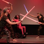 Artist Lee Papierowicz performing on stage in the Robert Schonhorn Arts Center.