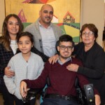 Artist Rick Cruz and family in the Robert Schonhorn Arts Center gallery during Full Circle 2019.
